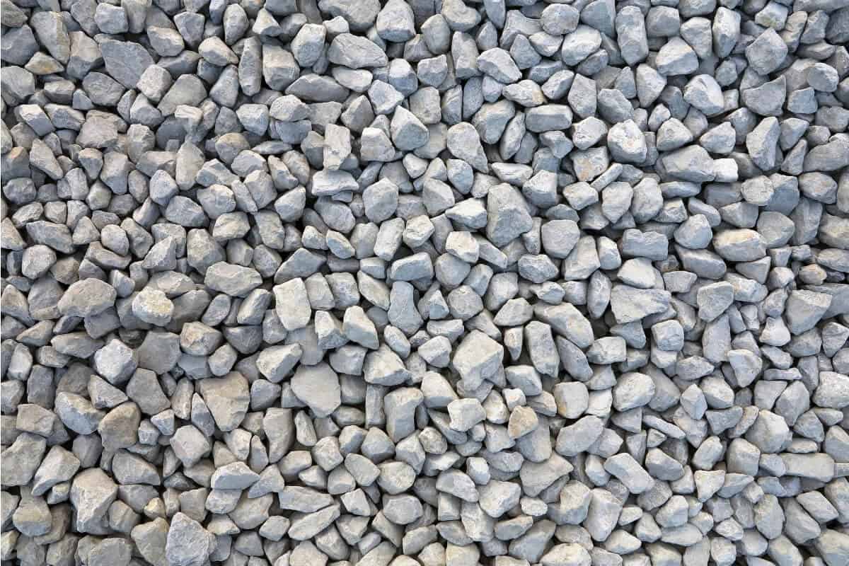 Close-up view of a large pile of small, irregularly shaped gravel in varying sizes.