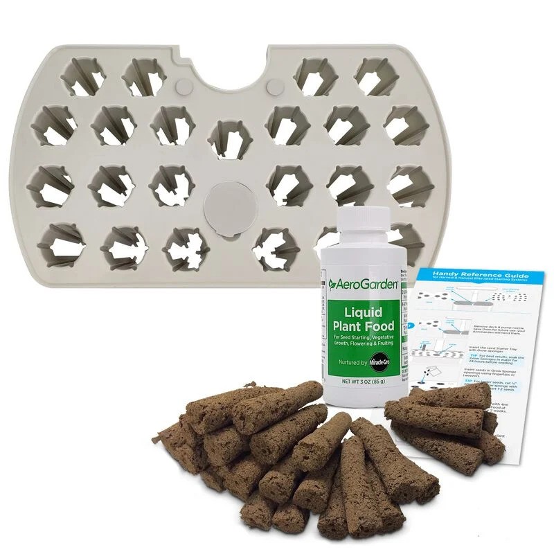 The image shows the best AeroGarden kit, featuring a white plastic insert with holes for planting, a bottle of AeroGarden Liquid Plant Food, a bundle of brown seed pods, and an instruction guide. 