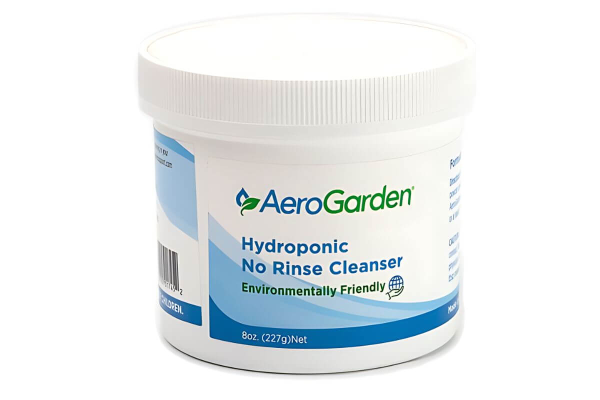 A container of AeroGarden Hydroponic No Rinse Cleanser. The white tub has a blue and green label.
